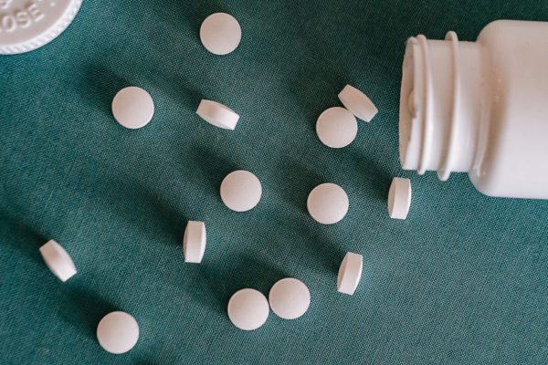 White pills spilled on table